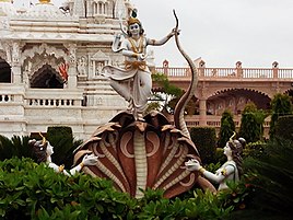 Statue outside temple depicting Kaliya conquered by Krishna