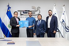 (From left to right) A representative of the Supreme Electoral Court, Nayib Bukele, Félix Ulloa, and Xavier Zablah Bukele holding documents which officially initiate the process of registering Bukele and Ulloa's candidacies for the 2024 elections.
