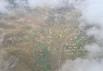 Aerial view of the ruined city, showing destroyed houses