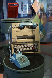 A photo of a Texas Silent Writer computer terminal with a blue telephone attached.