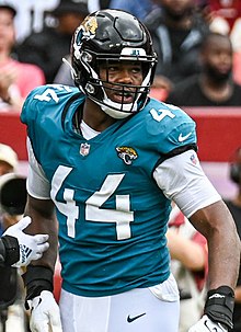 Travon Walker wearing a Jacksonville Jaguars helmet and uniform.