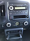 2006 Ridgeline RTS center dash with six–disc head unit, storage compartments, dual-zone climate controls, and power outlets