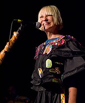 Sia Furler appears in a black outfit while performing live.