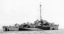 A right facing ship in quarter view with dazzle camouflage
