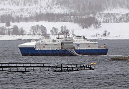 Fish farm Högtind in Norway with feeding barge