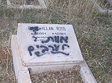Grave vandalized with "death to Arabs" in Hebrew