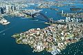 Sydney Harbour and Port Jackson displaying aerial views of the Sydney Harbour Bridge and the Sydney Opera House. The CBD is located to the far left of the photo.