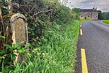The Milestone on the road by Parke's Castle, indicating 7 miles to Sligo and 5 miles to Dromahair.