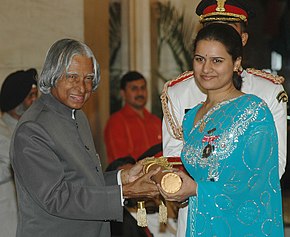 Koneru accepting an award from the President of India