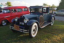 A color photograph of a 1926 Hudson motorcar parked on grass at an antique car show.