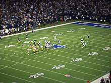 A photo of the Cowboys playing field with Packers and Cowboys on it.