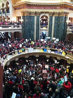 Overhead view of hundreds of people wearing red for the Teachers' union, protesting against Walker's bill