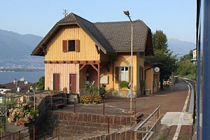 Two-story building with gabled roof next to single-track railway line