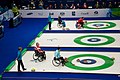 Wheelchair curling uses a specially adapted long stick to launch the "rock" down the ice. These players are delivering rocks in the 2010 Vancouver Paralympics.