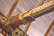 Here we see a decorated cross-beam in the church roof with a carving at the end depicting the mouth of a snake