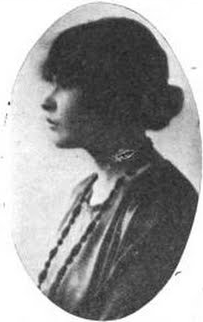 A young woman with fair skin and dark hair gathered to the nape, photographed in profile, in an oval frame