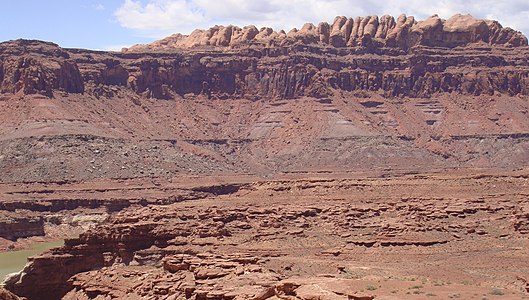 The Permian through Jurassic stratigraphy of the Colorado Plateau area of southeastern Utah that makes up much of the famous prominent rock formations in protected areas such as Capitol Reef National Park and Canyonlands National Park. From top to bottom: Rounded tan domes of the Navajo Sandstone, layered red Kayenta Formation, cliff-forming, vertically jointed, red Wingate Sandstone, slope-forming, purplish Chinle Formation, layered, lighter-red Moenkopi Formation, and white, layered Cutler Formation sandstone. Picture from Glen Canyon National Recreation Area, Utah.