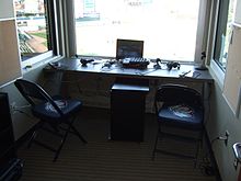 A radio booth overlooking a baseball field