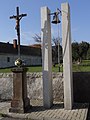 Cross and bell in the village square