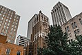 Several buildings in downtown Tulsa, Oklahoma. Philtower: Orange top, brick building in the center foreground; Mid-Continent Tower: to the right of Philtower with the greenish roof; First Place Tower: to the left of Philtower.