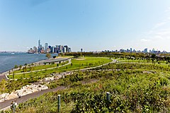 A view of the parklands on Governors Island; Manhattan's Financial District is visible in the distance.