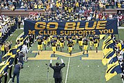 2009 team enters Stadium under the M Club banner to a Michigan Marching Band salute