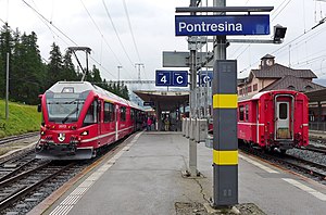 Red trains at island platform