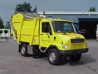 A small yellow garbage truck