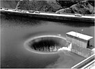 Bell-mouth spillway of Hungry Horse Dam in operation.