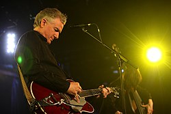 Mick Harvey performing live on-stage in 2012, with Rosie Westbrook