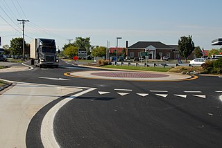 A roundabout at the intersection of Thompson Creek Road with the service road and ramps for eastbound US 50 on Kent Island