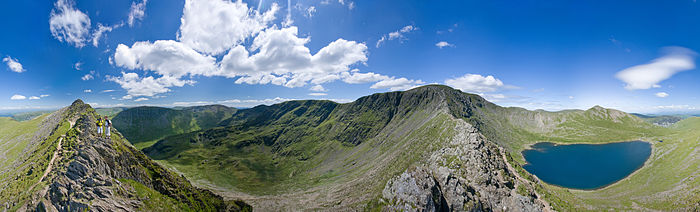 A 360 degree view from the middle of Striding Edge near the summit of Helvellyn in the Lake District. Helvellyn is the tallest summit just to the right of centre. Red Tarn is the small lake on the right, Catstye Cam is the fell directly behind Red Tarn, and Ullswater and the village of Glenridding are visible on the horizon along the far left corner.