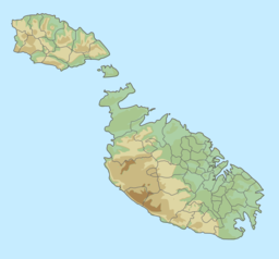 Map of the Maltese archipelago with a red dot on the northeastern coast of the island of Gozo showing the location of San Blas Bay.