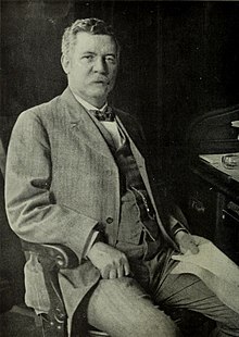 Black & white photograph of a man - Morgan - sitting.