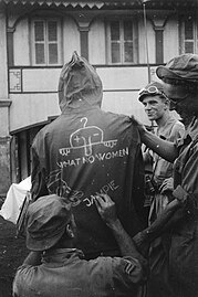 Comrades had drawn Chad together with the statement "What no women", the head of Donald Duck and the word "Jampie" on the back of a rain jacket of a Dutch soldier, 1948.