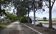 Walking trail near the Currents Bridge and the city, at the mouth of the Rons River