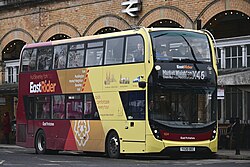 An EastRider-branded yellow and red double-decker bus at York railway station