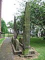 Image 22'Giants Grave', St. Andrew's churchyard, Penrith, an unusual arrangement of two Viking-age cross-shafts with four hogbacks (in the foreground). In addition, there is a smaller, Viking-age, wheel-headed cross just visible in the background (from History of Cumbria)
