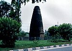 A stone pillar close to a road