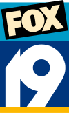 A teal box, atop which sits a black tilted box with the Fox network logo. Beneath it, a white stylized sans serif "19" on a blue background, underlined in yellow.