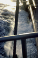 Storm waves coming abeam from starboard, causing water on deck.