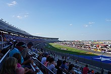 A wide shot of the Texas Motor Speedway's front stretch in 2017, with the grandstands and the facility's infield being photographed.