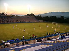 A partially filled open air soccer stadium