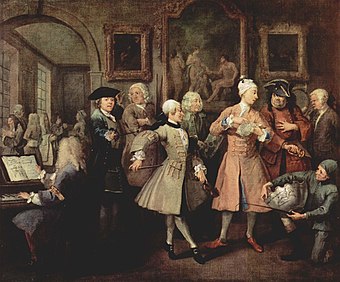 A Rake's Progress: II – The Levée by William Hogarth, c. 1732–1734; Figg stands third from the left, between the fencing master and the dance instructor, wearing a white wig and holding two quarterstaffs.
