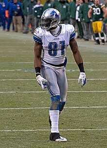Calvin Johnson on an NFL field in a Detroit Lions jersey and helmet.