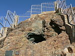 This piece of land, which is owned by the O'okiep Copper Company Limited, contains a mine shaft sunk by Commander Simon van der Stel on an expedition to the Copper Mountains in 1685. In 1681 a group of Namaquas brought pieces of copper ore to the Cape. Simon van der Stel’s little copper mine is situated high up on the slope of the Copper Mountains, about 11 kilometres east of Springbok, on the road to Aggeneis and Pofadder. Turn-off on R64, just over 7km outside Springbok. Take Carolusberg turn-off and then the site is indicated by signboards from there. Type of site: Mine