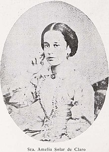 B&W oval portrait of a woman with hair in an up-do, wearing a pale-colored dress.