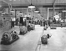 Interior of an electrical shop with machinery in the foreground and people in the background