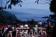 Diners around tables on the terrace of the Nepenthe restaurant can see many miles down the Big Sur coast.