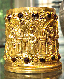 A small, ornate gold container